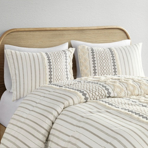 Luxury cotton duvet set with chenille in neutral tones featuring textured patterns on bed