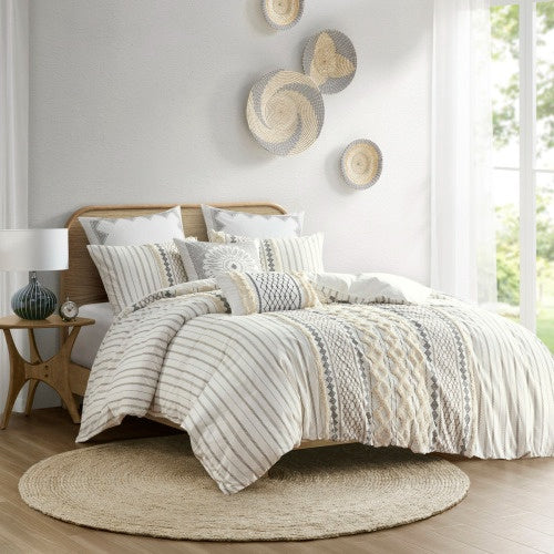 Luxury cotton duvet set with chenille in neutral tones on bed with decorative pillows in bright bedroom