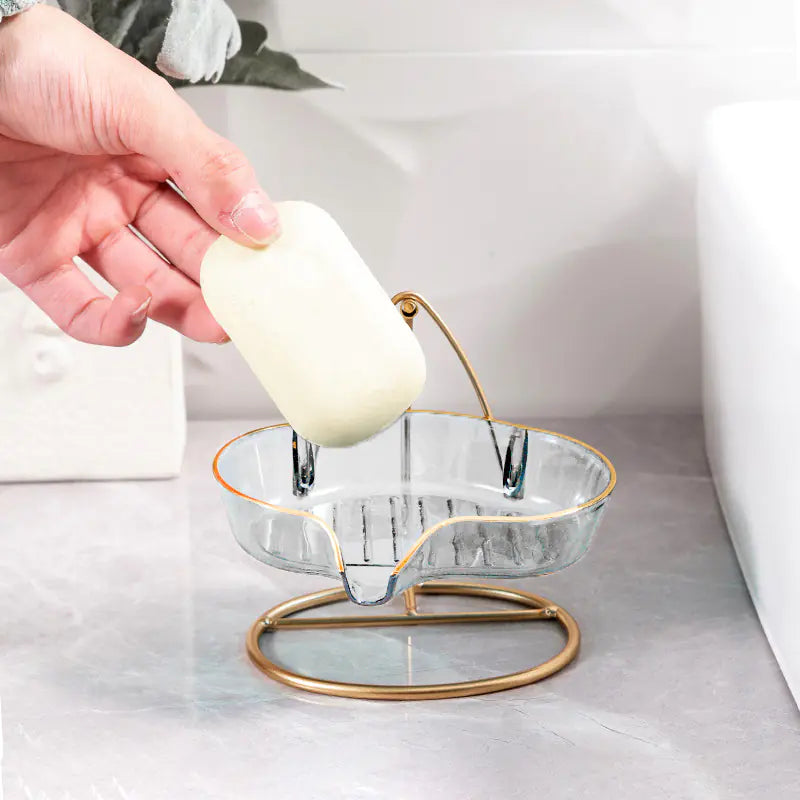 Luxury soap holder with drainage featuring clear glass dish and gold metal stand on bathroom counter
