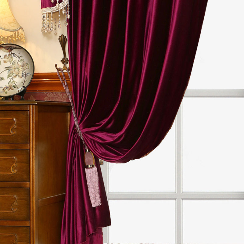 Shopi Vella luxury velvet blackout curtains in deep burgundy tied back with decorative tassel in elegant room