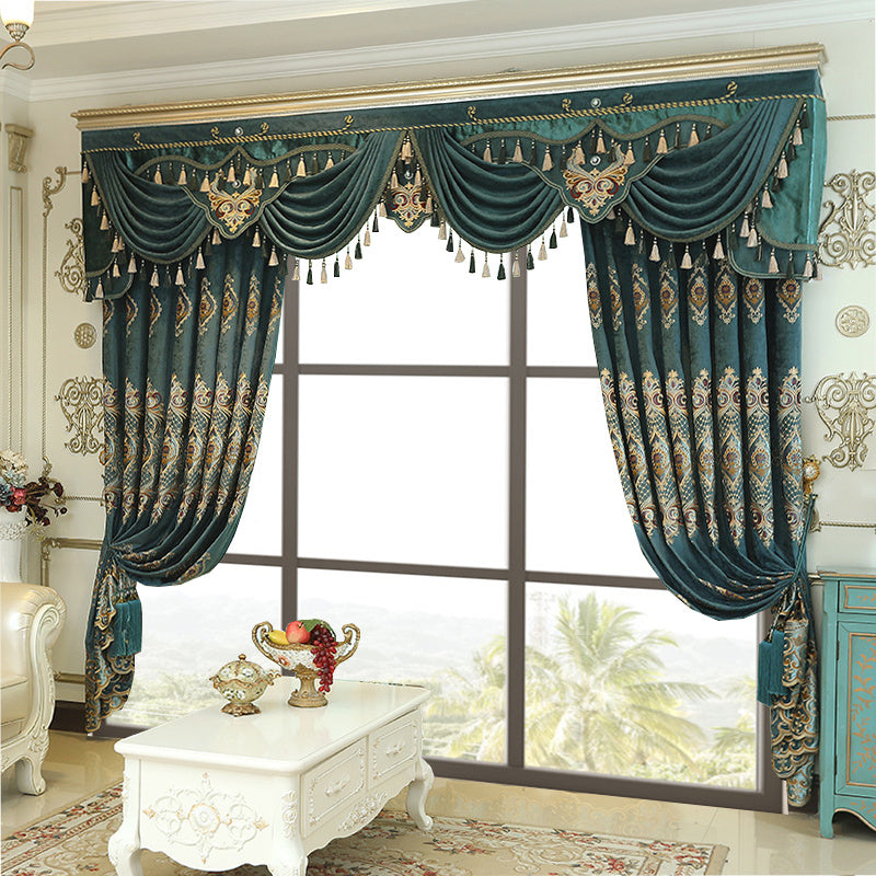 Shopi Vella luxury velvet blackout curtains in teal with ornate gold embroidery and tassels hanging in elegant living room