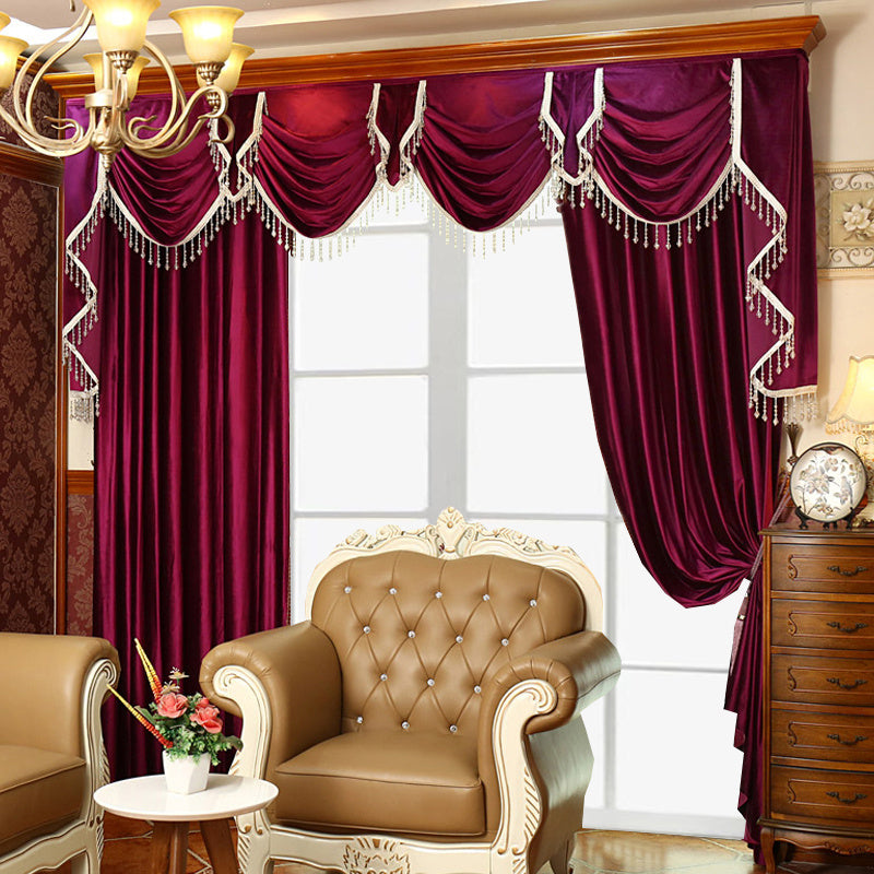 Luxury velvet blackout curtains in deep burgundy with elegant drapes and tassels in a classic living room