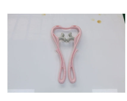 Shopi Vella manual neck massager tool in pink with gray massage nodes for home use
