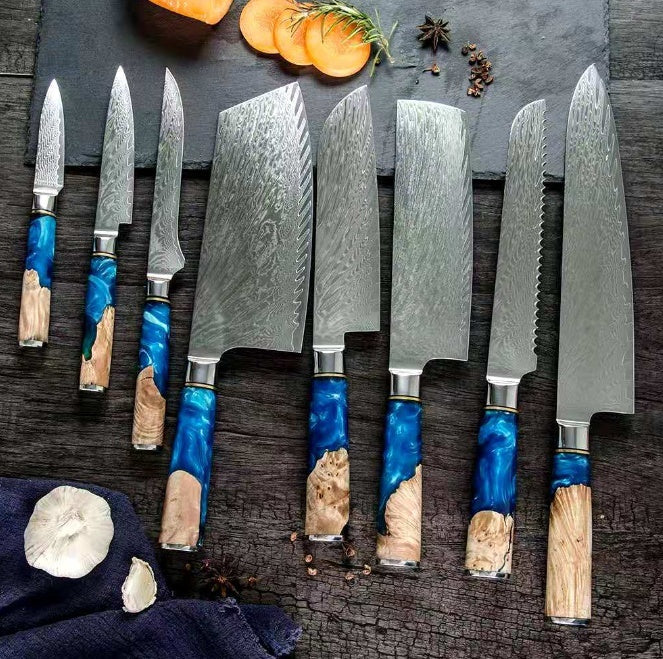 Shopi Vella meat chopping knife set with blue and wood handle and textured steel blades on dark surface