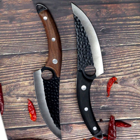 Shopi Vella kitchen meat cutting scimitar knife with curved blade and textured handle on wooden surface