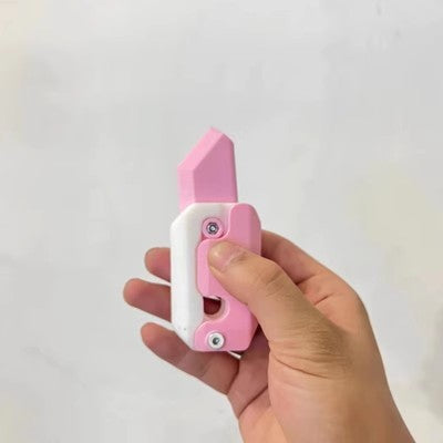 Hand holding a pink and white mini 3D printing toy knife stationery item from Shopi Vella