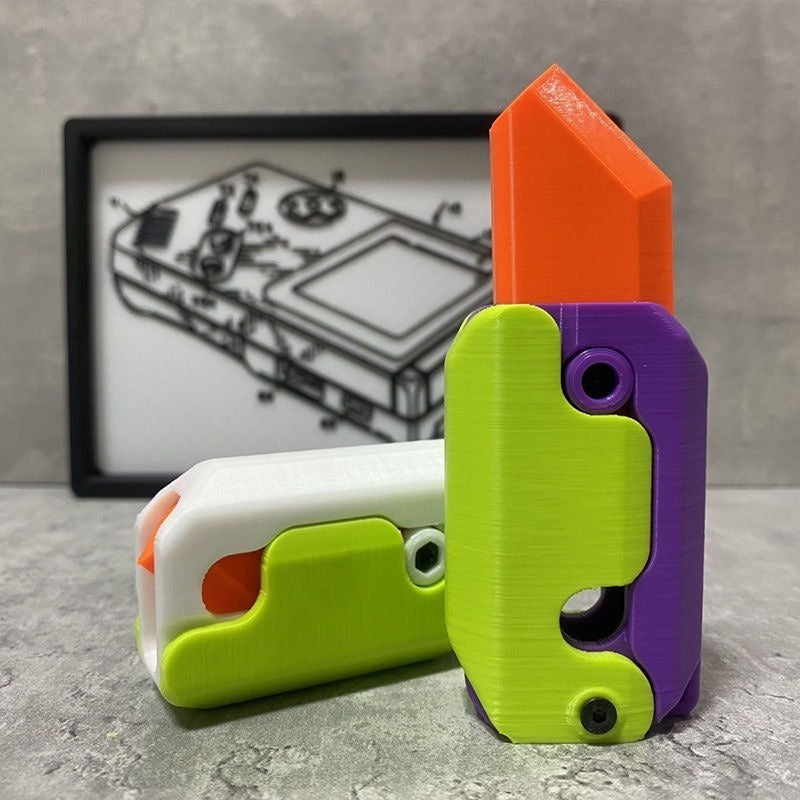 Shopi Vella mini 3D printing toy knife in bright green purple and orange with a compact design