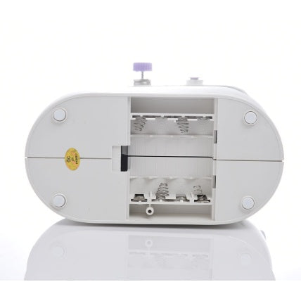 Shopi Vella mini household sewing machine showing the bottom view with thread spools and motor compartment