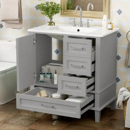Modern bathroom cabinet with storage in gray featuring multiple drawers and a cabinet door under white sink