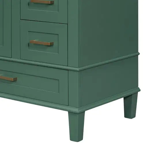 Close-up of modern bathroom cabinet with storage in green finish featuring bronze handles and raised legs