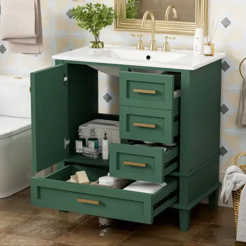 Modern bathroom cabinet with storage in green featuring multiple drawers and a white countertop with gold faucet
