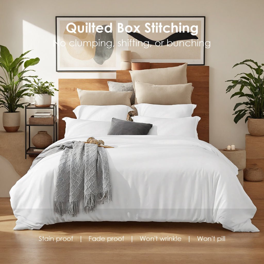 Shopi Vella modern bedroom quilted bedding set in white with layered pillows and a gray throw in a stylish room