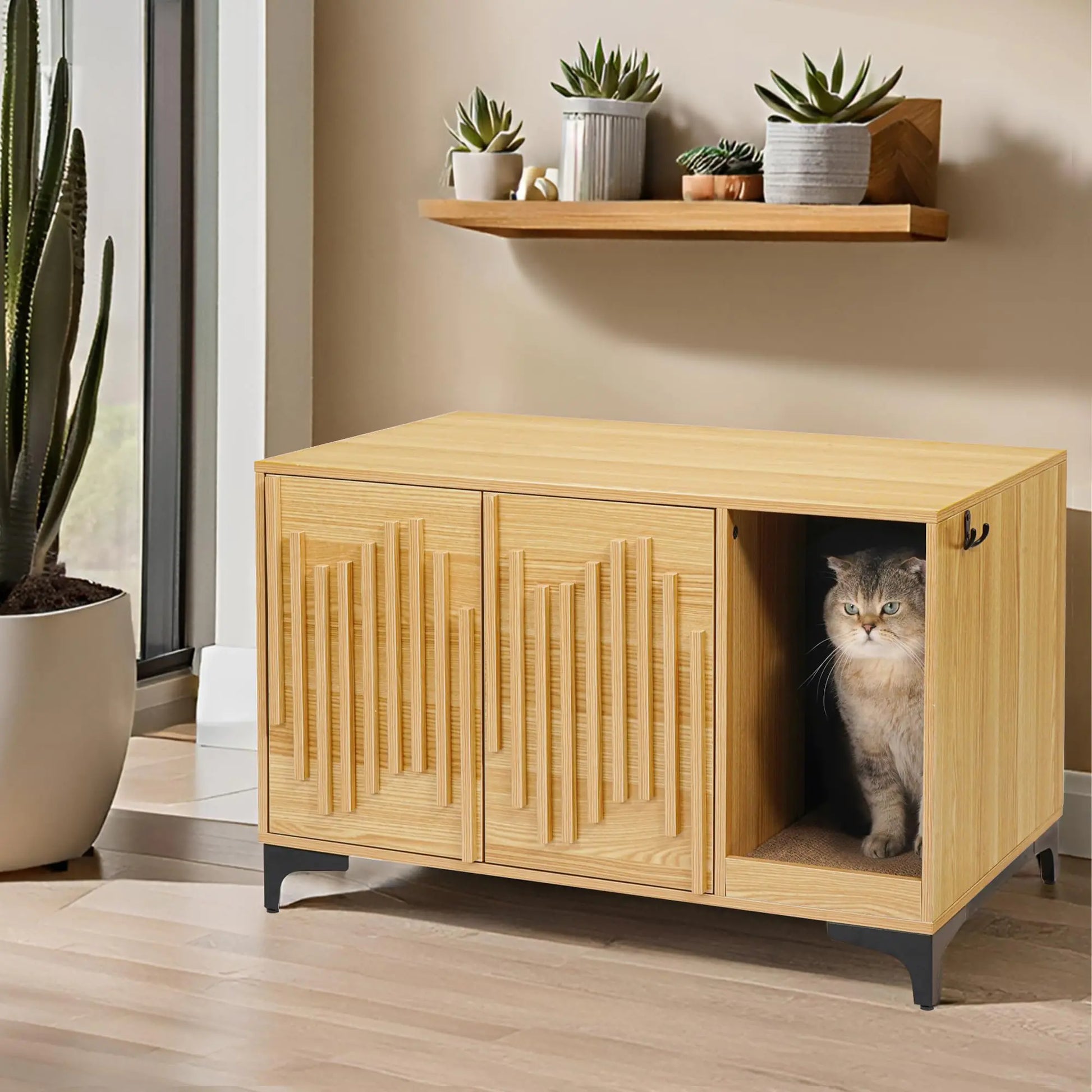 Modern cat litter box furniture in light wood with decorative doors and a cat inside on black legs