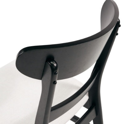 Close-up of black wooden modern dining chair set with curved backrest and white seat cushion
