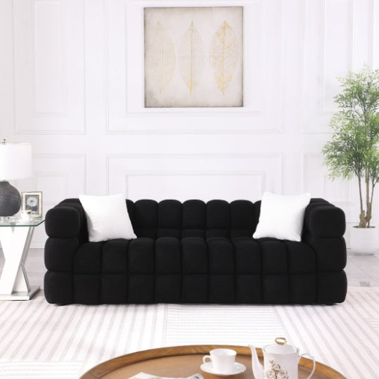 Shopi Vella modern fabric sofa for living room in black with tufted upholstery and white accent pillows