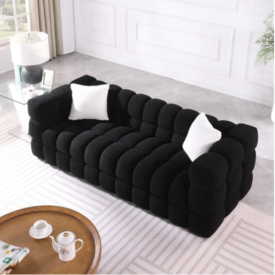 Shopi Vella modern fabric sofa for living room in black with tufted design and white pillows
