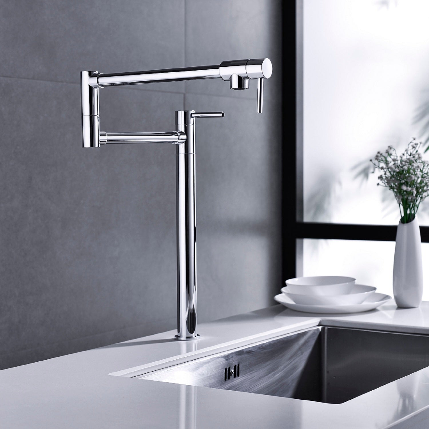 Shopi Vella modern folding sink faucet in chrome finish installed on a white countertop with a gray tiled wall background