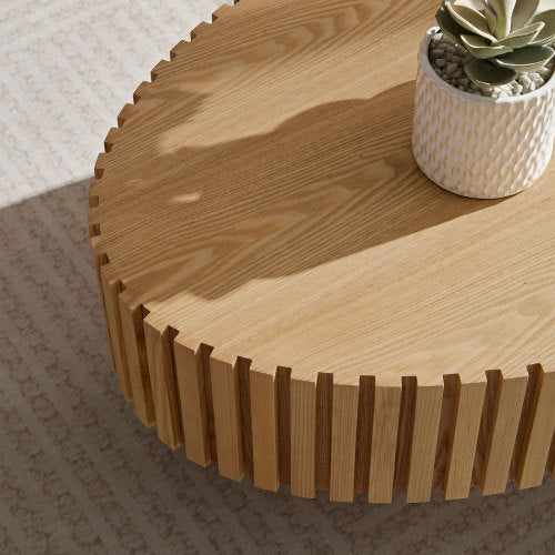 Shopi Vella modern handmade drum coffee table in natural wood with slatted edges and decorative plant