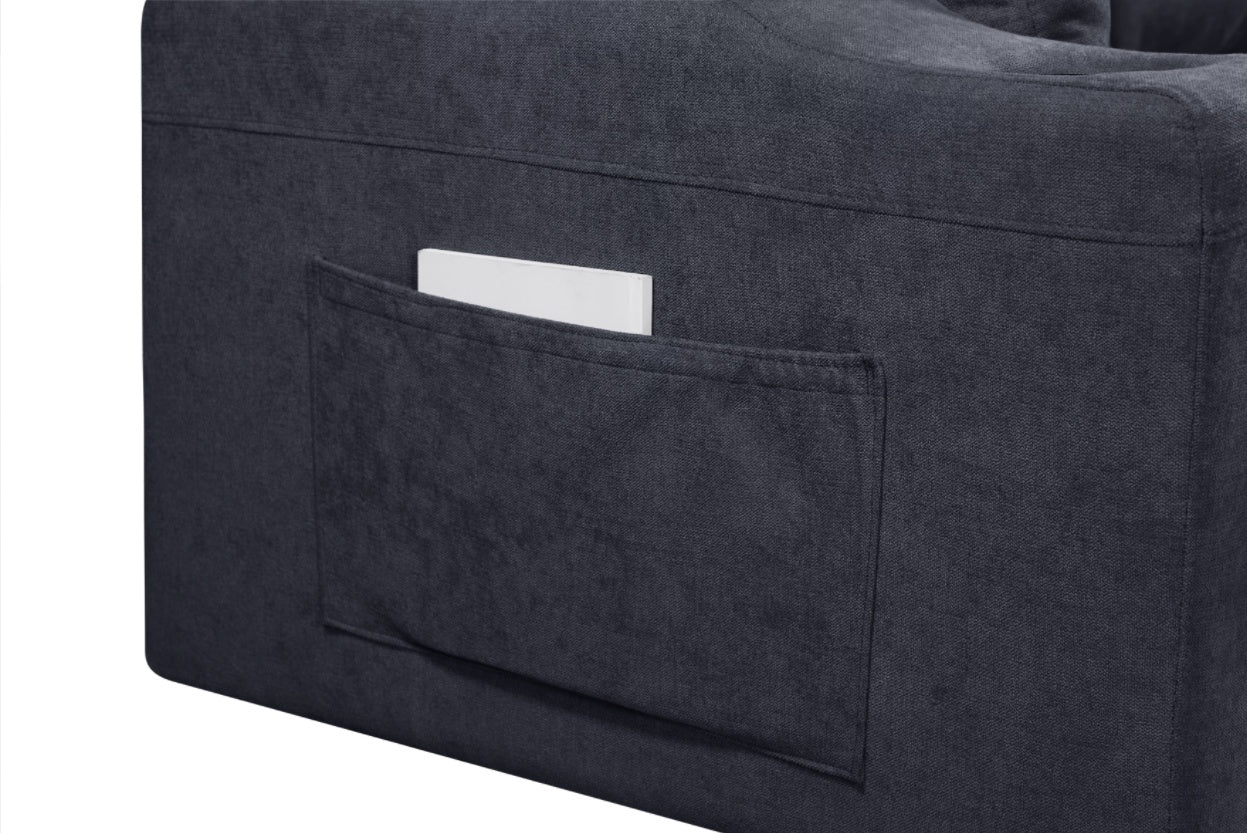 Close-up of black modern sectional sofa with hidden compartments showing fabric pocket storage