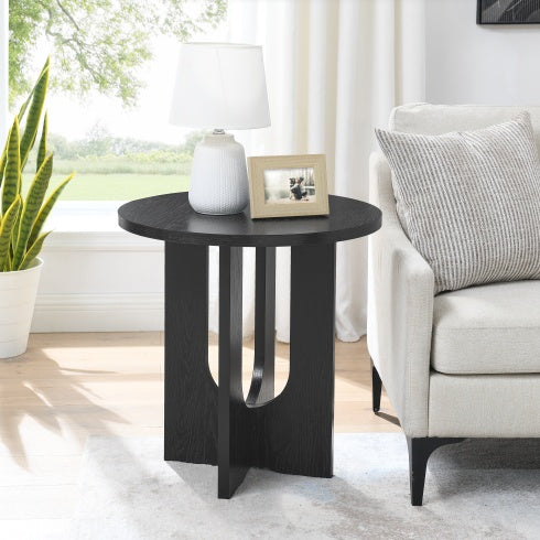 Shopi Vella modern solid wood coffee table in black with round top next to beige sofa in bright living room