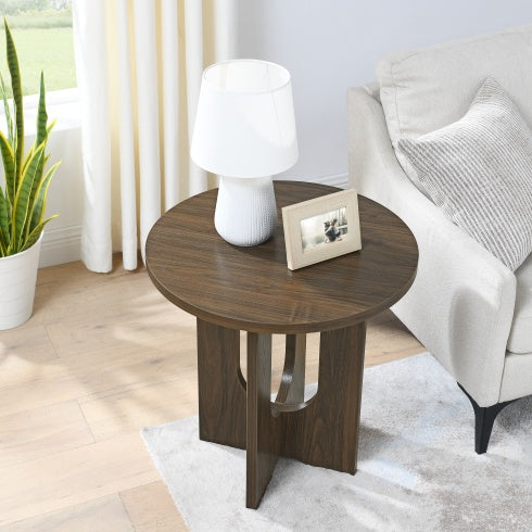 Modern solid wood coffee table with round top and unique base next to beige sofa in living room