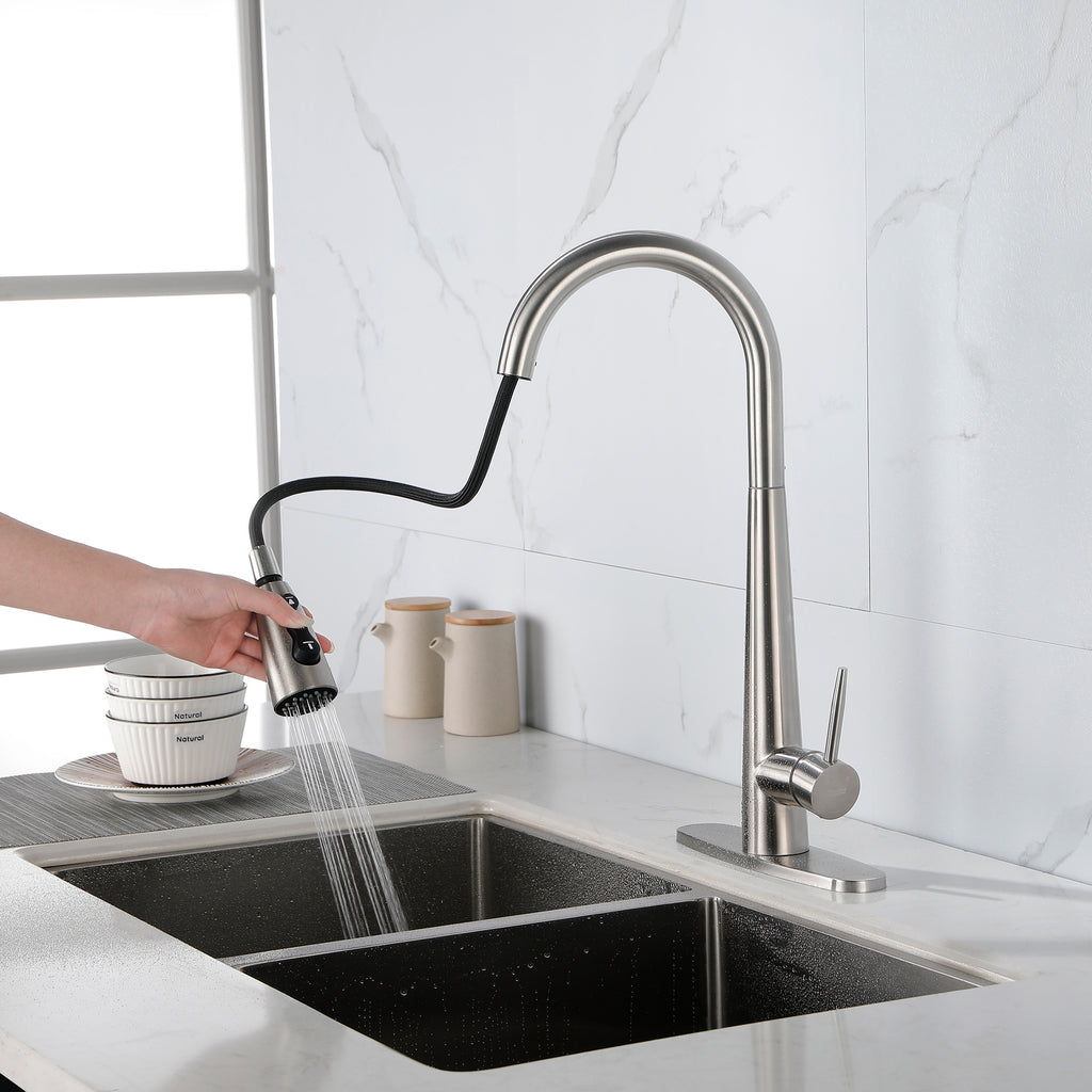 Modern stainless steel kitchen faucet with pull-down spray head installed on white countertop by Shopi Vella