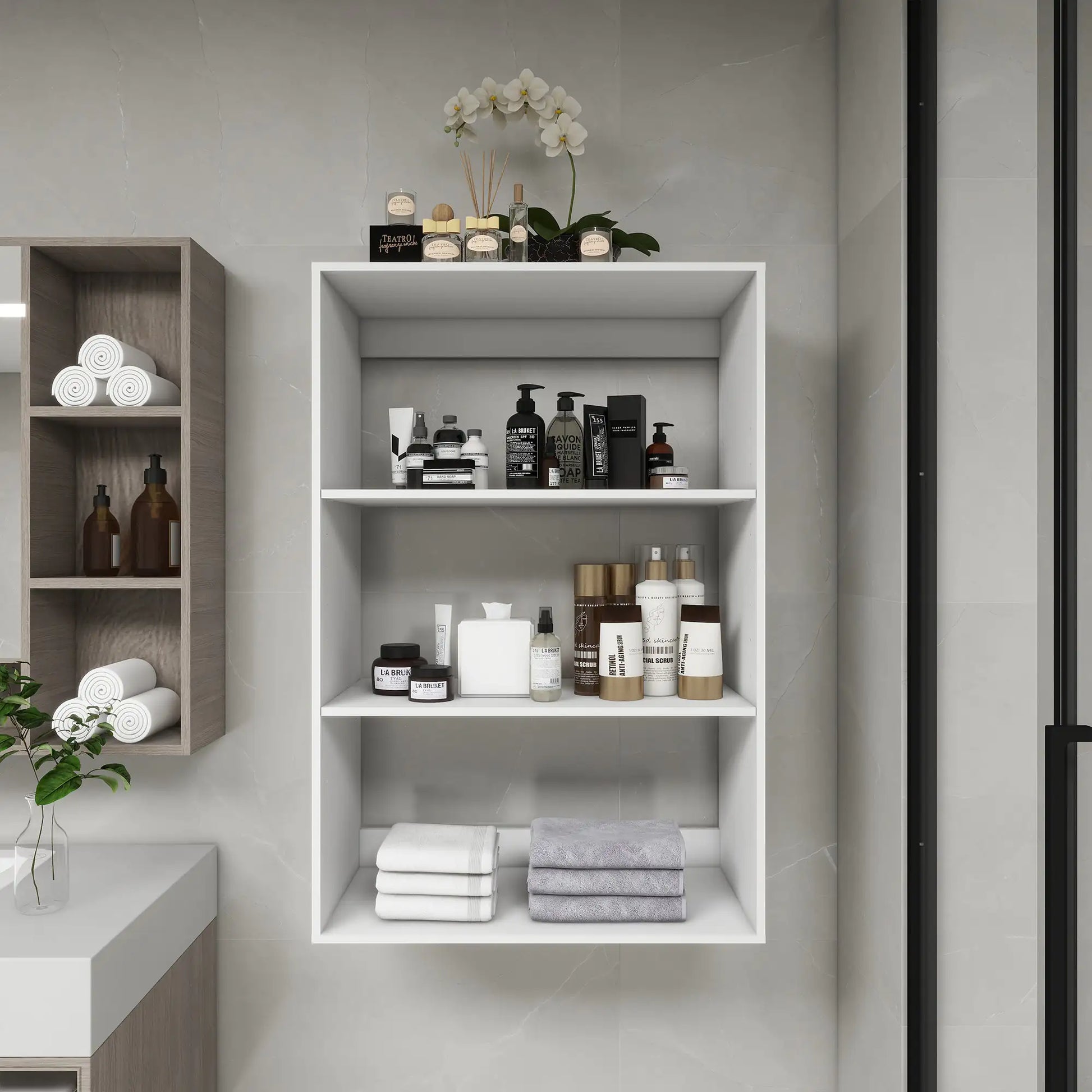 White wall mounted bathroom shelves holding toiletries, towels, and decorative orchid plant