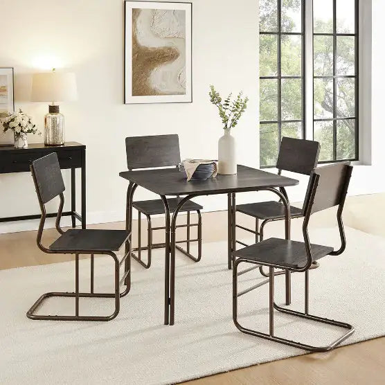 Modern wooden dining table set with four matching chairs in a bright, minimalist dining room