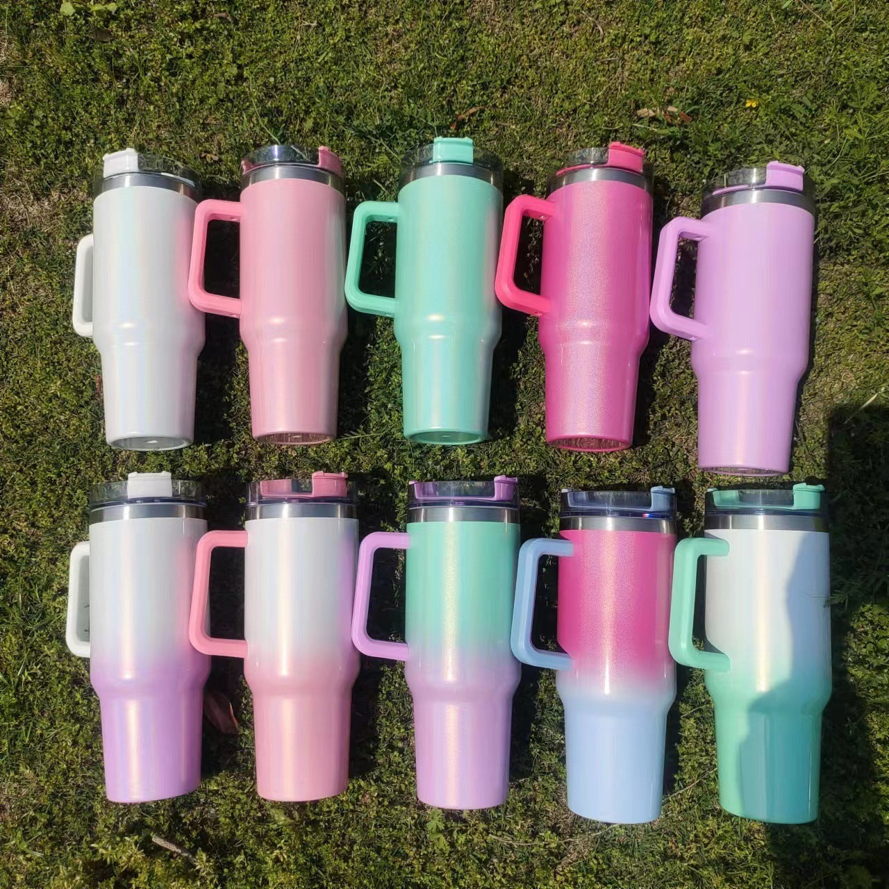 Shopi Vella colorful double-layer stainless steel cups with handles arranged on grass