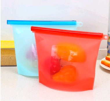 Shopi Vella kitchen storage silicone food storage bag set with red and blue seals holding fresh vegetables