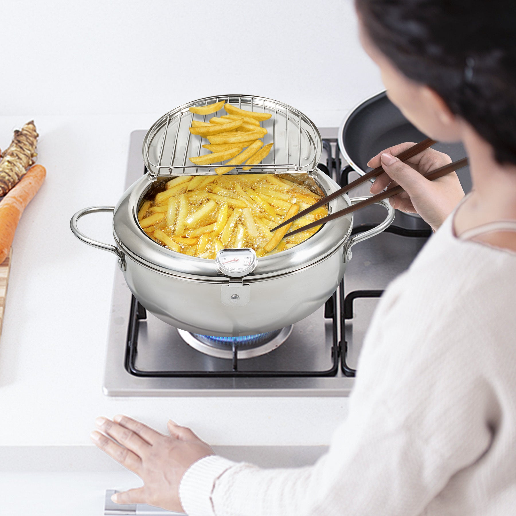 Shopi Vella multi-purpose kitchen storage pot used for frying fries on a gas stove with a strainer insert