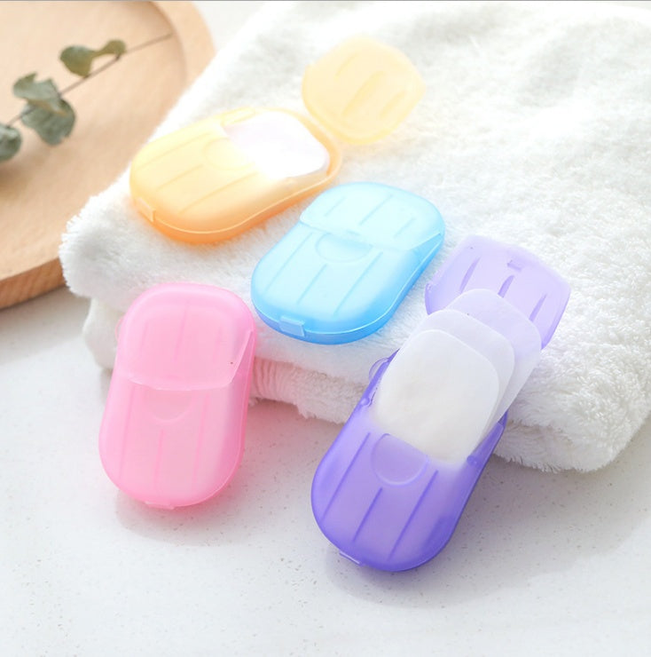 Shopi Vella bathroom storage cases holding disposable hand soap paper in pastel colors on white towel