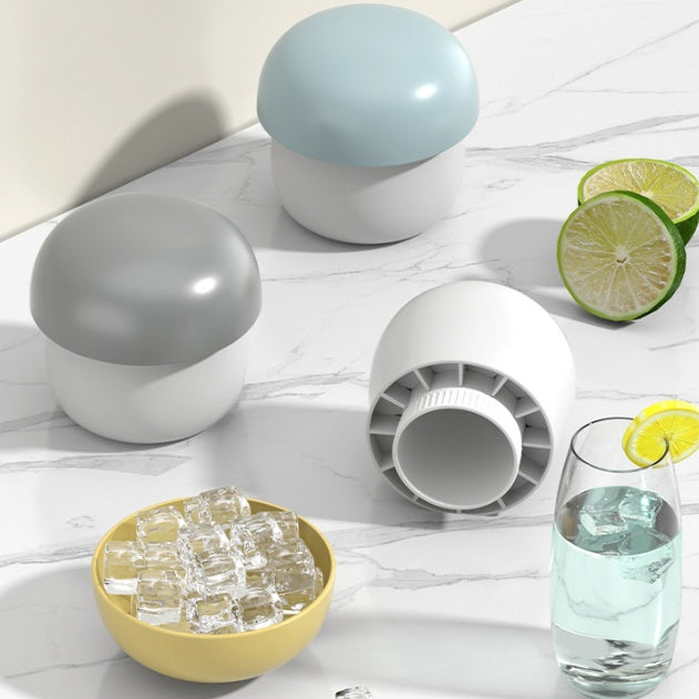Shopi Vella mushroom ice cube mold set with pastel-colored tops on marble kitchen counter with lime slices and glass of water