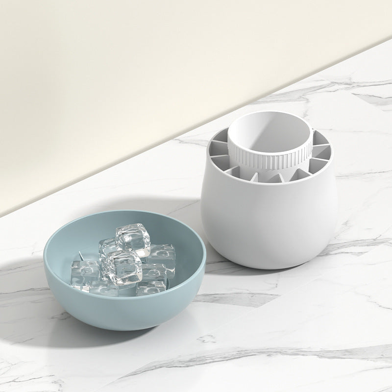 Shopi Vella mushroom ice cube mold in white on marble countertop with clear ice cubes in blue bowl
