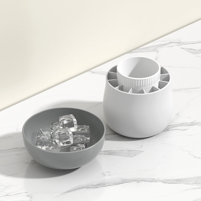 Shopi Vella mushroom ice cube mold with clear ice cubes in a gray bowl on marble countertop