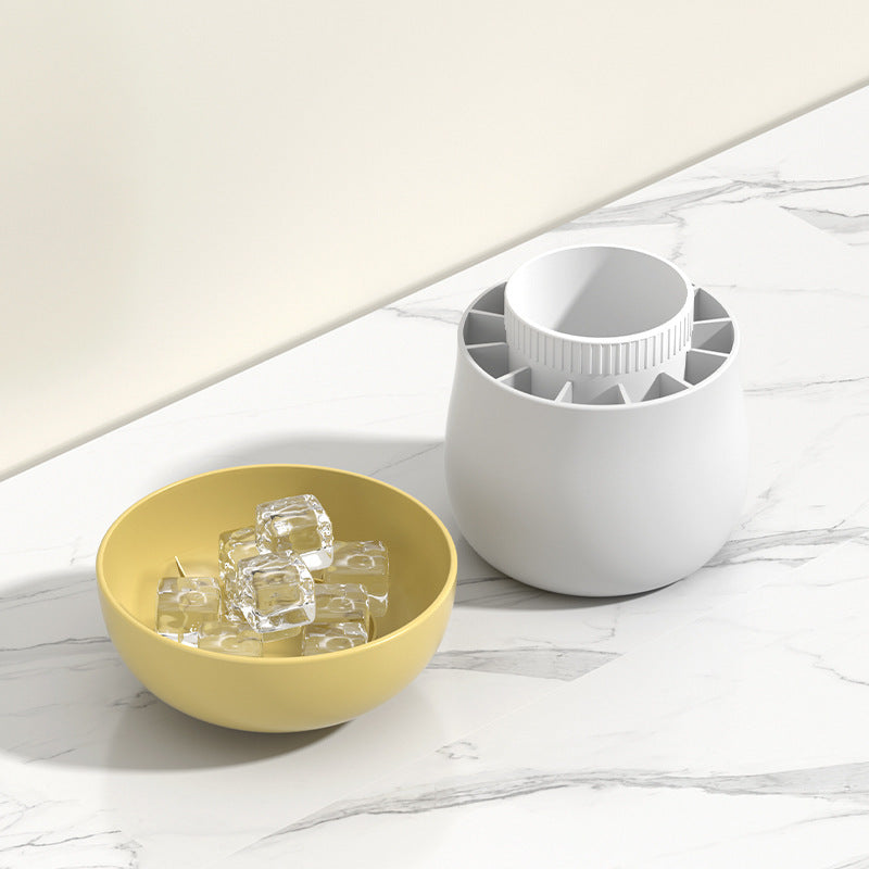 Shopi Vella mushroom ice cube mold in white with clear ice cubes in a yellow bowl on marble surface
