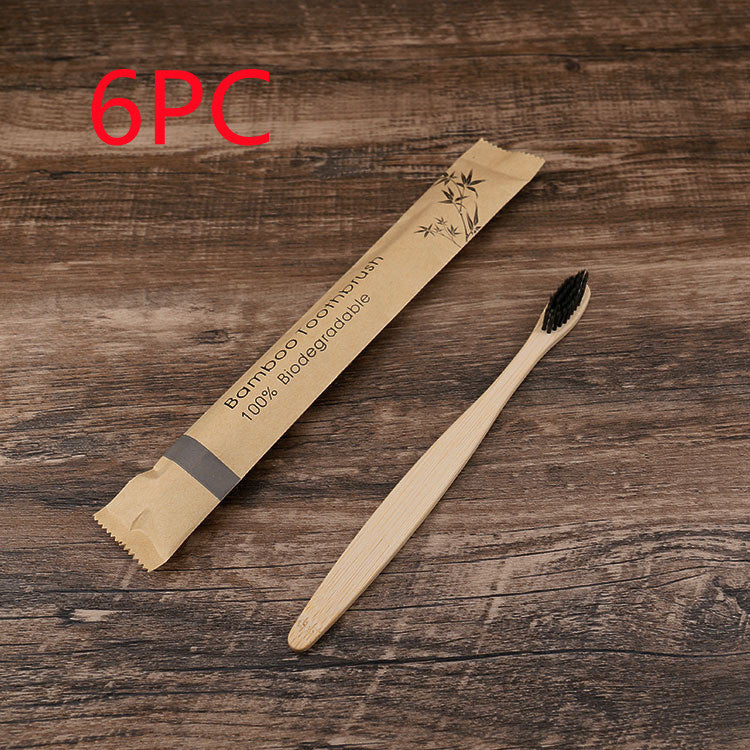 Natural bamboo toothbrushes soft bristle with biodegradable bamboo packaging on wooden background