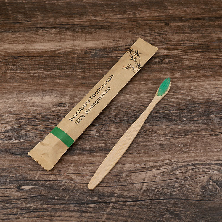 Natural bamboo toothbrushes soft bristle with eco-friendly biodegradable packaging on wooden surface