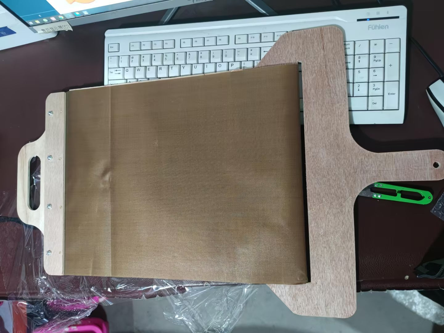 Shopi Vella non stick pizza transfer board made of wood with a brown non-stick surface for easy pizza handling