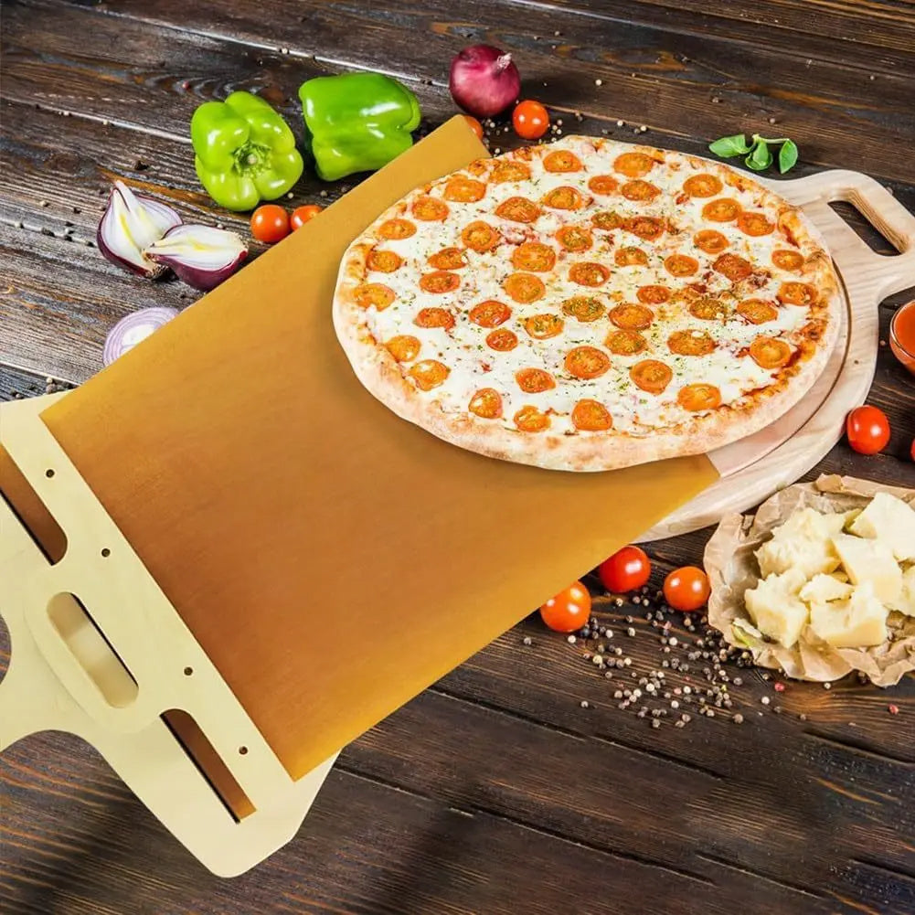 Shopi Vella non stick pizza transfer board with a pepperoni pizza and fresh vegetables on a wooden table