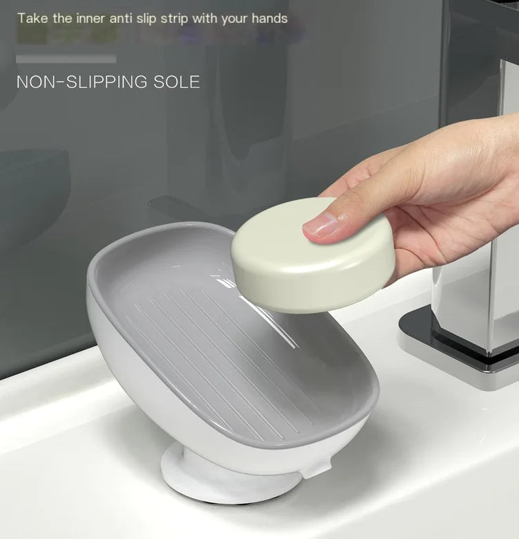 Octopus suction cup soap dish in gray with non-slipping sole attached to bathroom sink holding white soap
