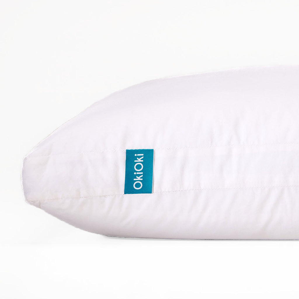 Shopi Vella white pillow case on soft supportive sleep pillow with blue OkioKi tag
