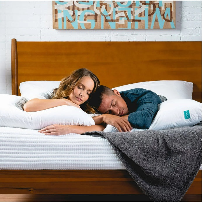 Couple sleeping comfortably on bed with Shopi Vella soft supportive sleep pillow cases