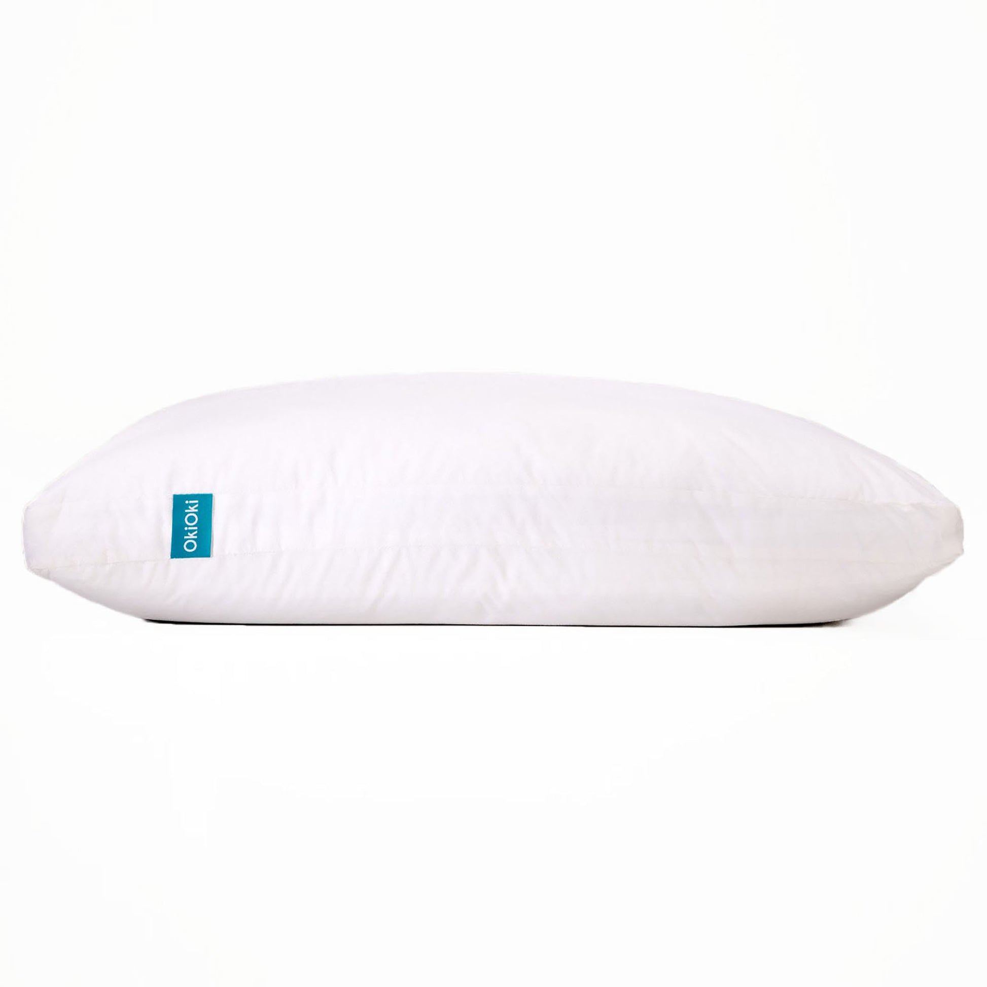 White Shopi Vella pillow case on soft supportive sleep pillow with blue tag