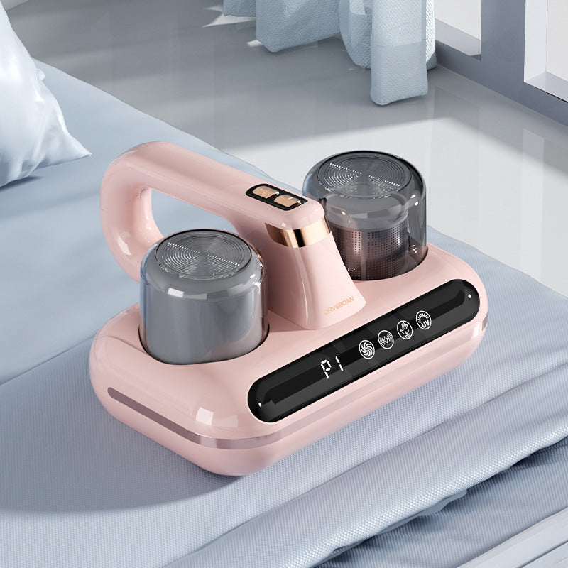 Shopi Vella cordless mattress vacuum cleaner in pink with dual dust containers on a blue mattress