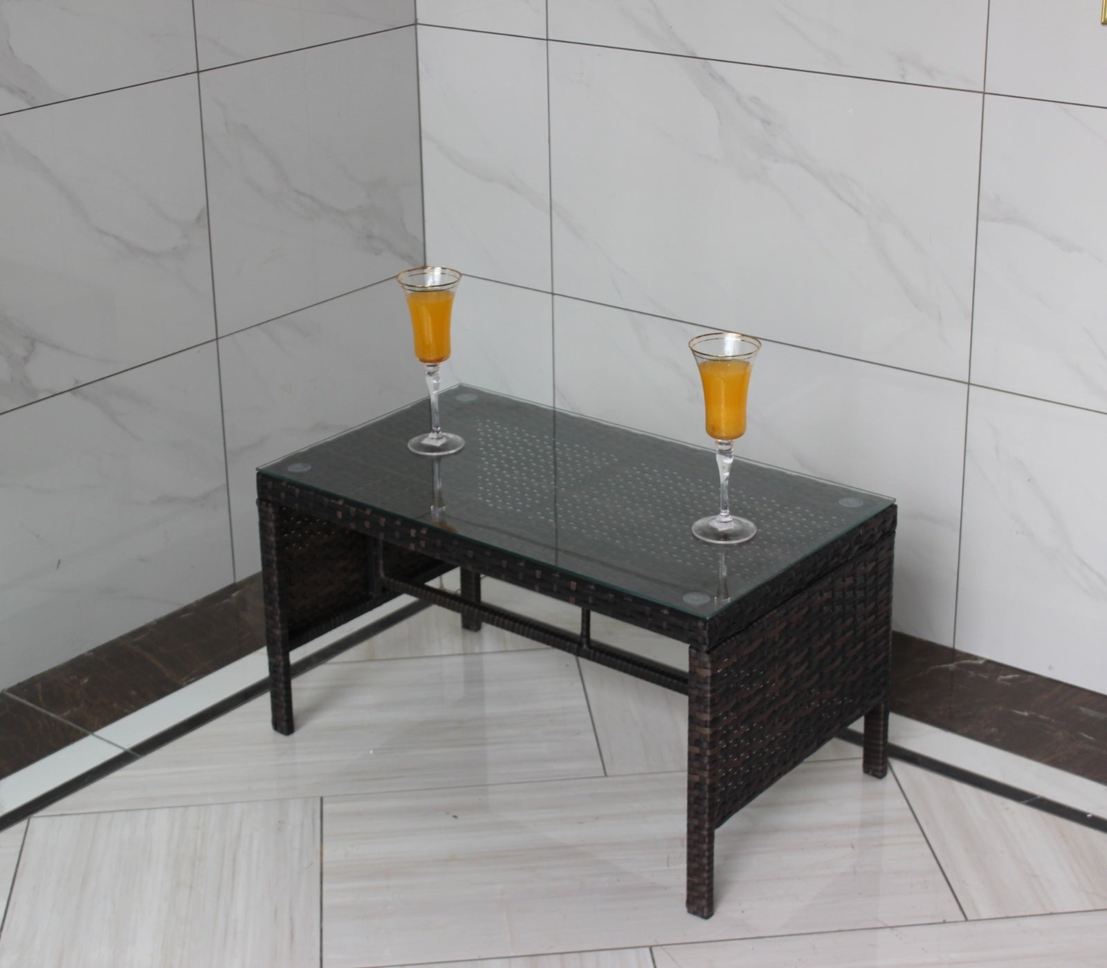 Shopi Vella outdoor patio coffee table with glass top and dark woven rattan frame