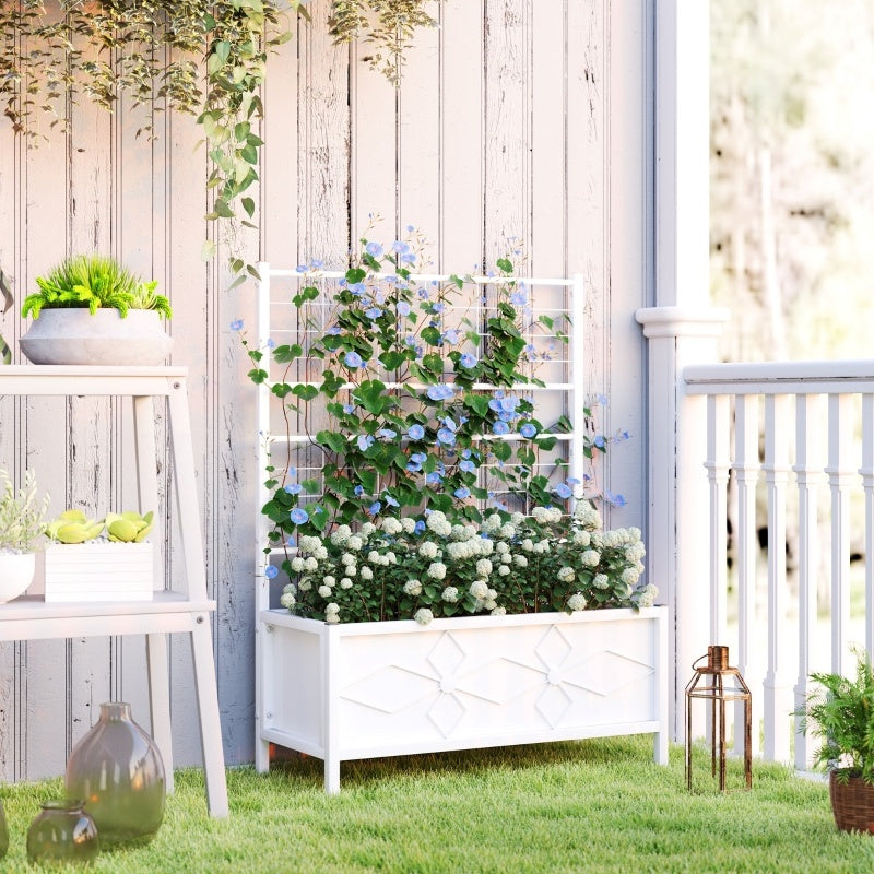 Shopi Vella white outdoor planter box with trellis filled with green and flowering plants on a grassy porch