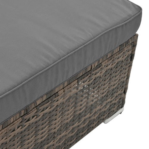 Close-up of gray cushioned outdoor wicker patio furniture set piece with woven rattan design