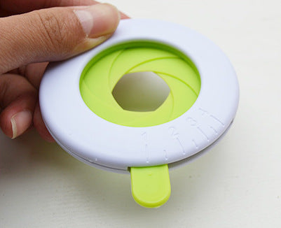 Shopi Vella pasta portion control tool kitchen storage gadget in white and green held in hand