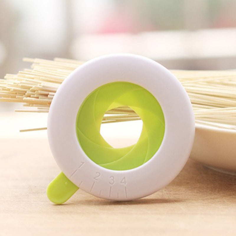 Shopi Vella pasta portion control tool in white and green with size markings for kitchen storage